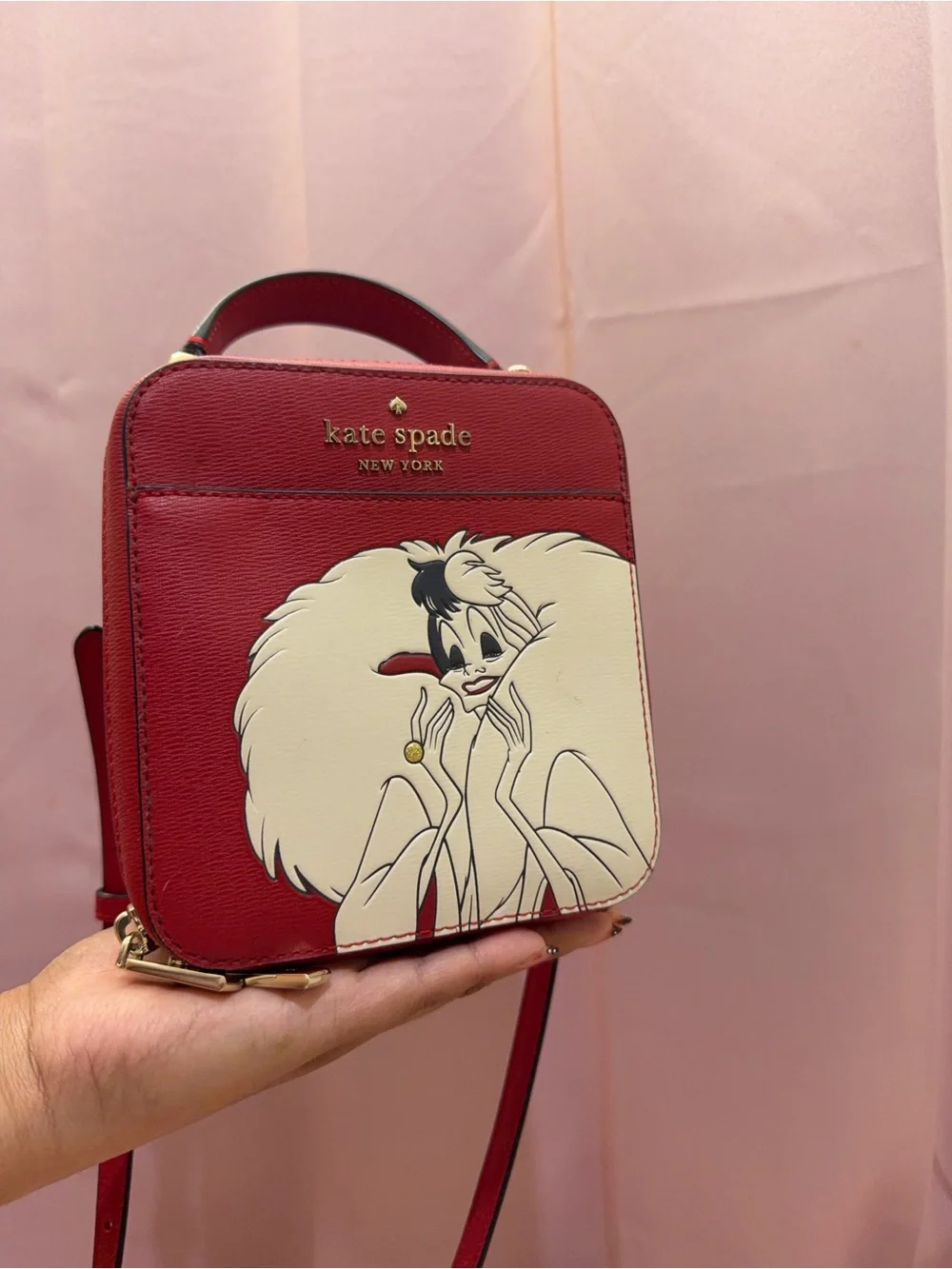 kate spade red and cream Cruella-themed crossbody bag